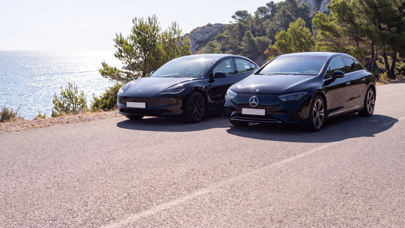 Black Tesla Model 3 and Mercedes EQE, exterior view